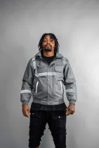 Industrial Work Jacket 4 Model wearing the Reign Gear gray industrial work jacket with reflective detailing