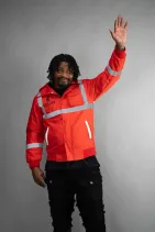 Industrial Work Jacket 14 Model wearing the Reign Gear red industrial work jacket with reflective detailing