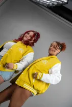 Classic Varsity Jacket 43 Two models wearing Reign Gear women's yellow and white classic varsity jackets