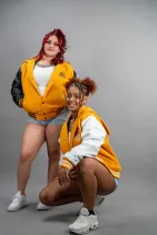 Classic Varsity Jacket 46 Two models wearing Reign Gear women's yellow and black classic varsity jackets
