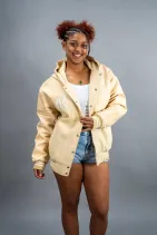 Classic Varsity Jacket 21 Reign Gear women's water-repellent hooded varsity jacket in cream.