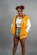 Classic Varsity Jacket 32 Reign Gear women's gold and white water-repellent hooded varsity jacket.